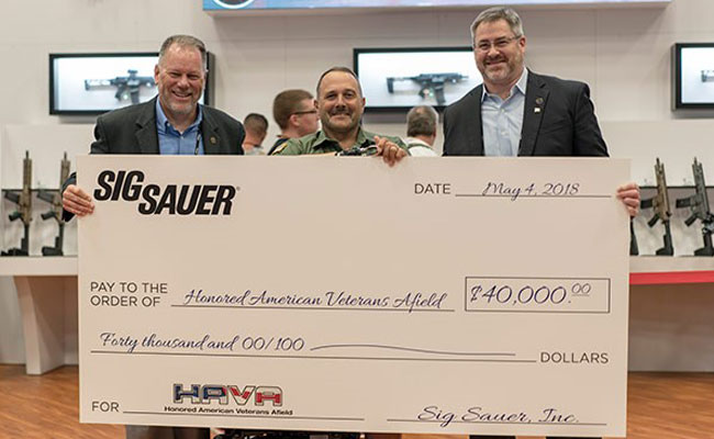 Pictured left to right: HAVA Chairman and CEO Tom Taylor, HAVA Learn to Shoot Again Director Rick Cicero, SIG SAUER Electro-Optics President Andy York